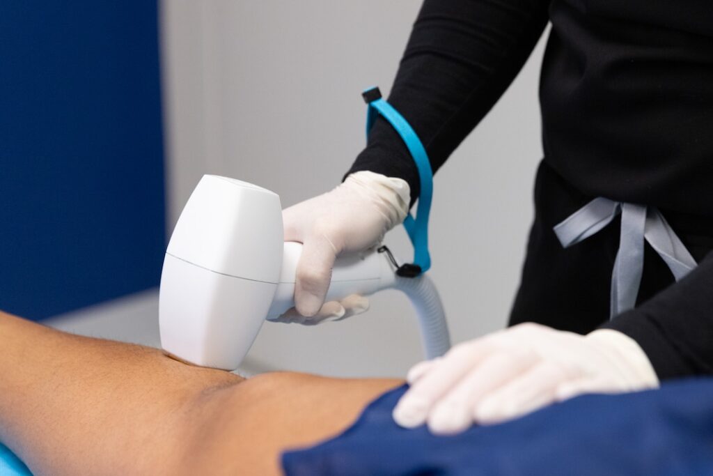 A Faulkner Plastic Surgery & Aesthetics provider glides the Diolaze device across a patient's leg, ideal laser hair removal near Bethesda, MD.
