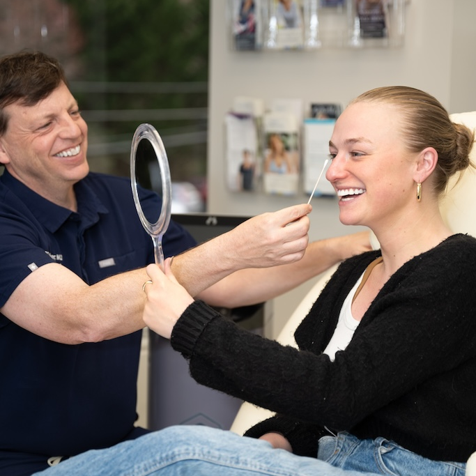 Dr. Faulkner assesses a patient's skin prior to mole removal in Rockville.